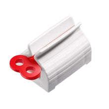 Stand and squeezer for rolling toothpaste tubes